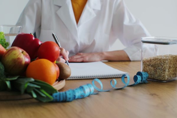 Nutritionist giving consultation to patient with healthy fruit and vegetable, Right nutrition and diet concept